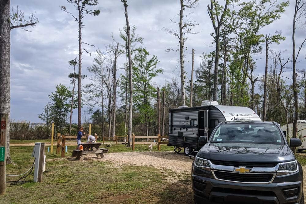 Truck, camper and trees in background
