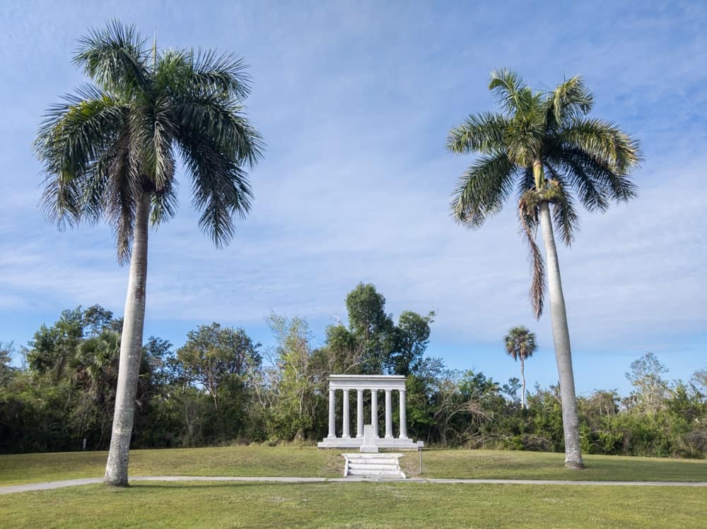Architectural memorial between two tall royal palm trees