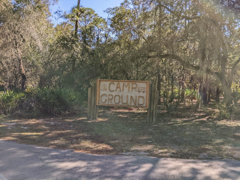 wooden sign with the words "camp ground"