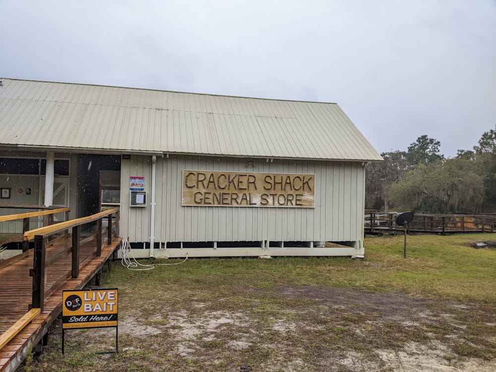 outside of store with signs that says "Cracker Shack General Store"