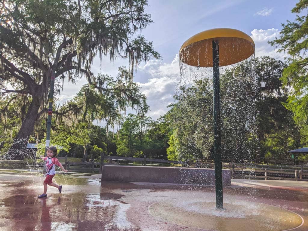 Girl playing in splash pad at Hart Springs Park.