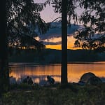 family camping in front of lake