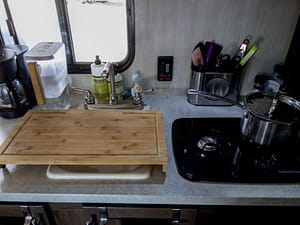 camper sink with cutting board over sink