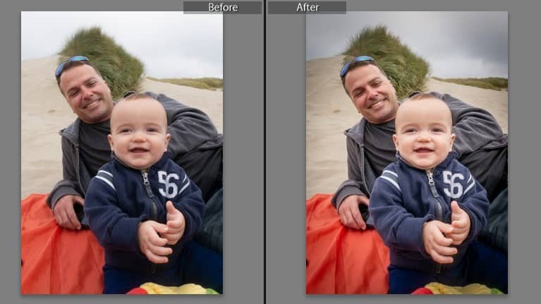 smiling baby sitting on sand in front of man