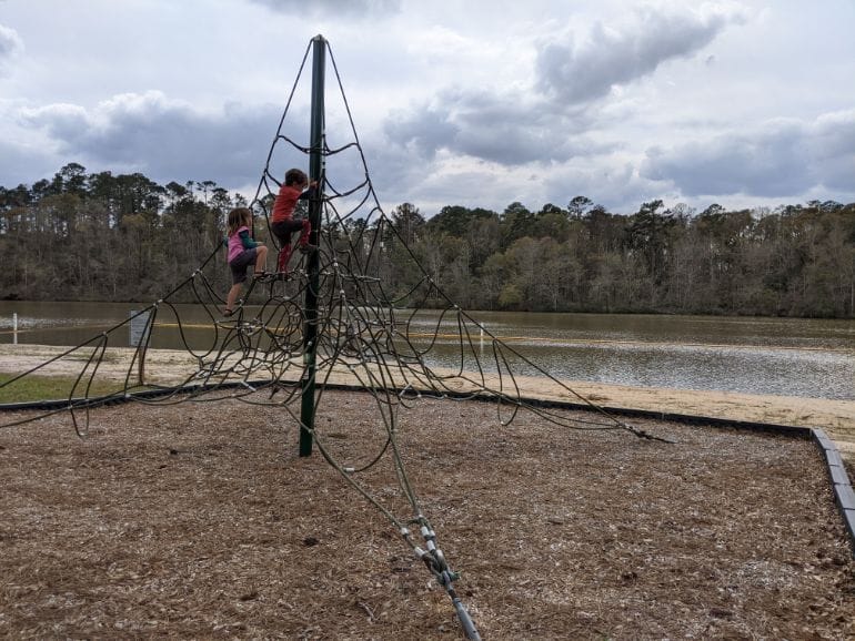 Two little kids climbing a rope structure at Kolomoki Mounds State Park
